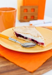 Piece of homemade cake with berries and meringue