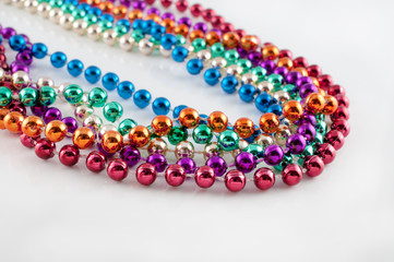 Mardi Gras necklaces on white
