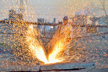worker cut metal using blowtorch