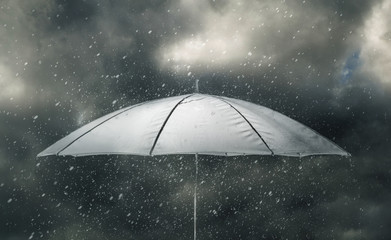 Umbrella in thunderstorm