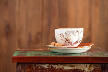 Cup of coffee with sugar on a beautiful rustic background