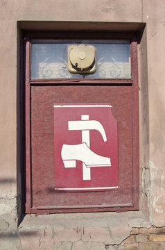 Shop Window With Vintage Shoe Repair Shop Sign