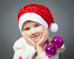 Portrait of a charming little girl in Santa's hat