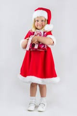 Beautiful girl in a red new year cap with gift