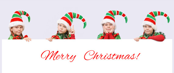 Four girls in suits of Christmas elf with banner