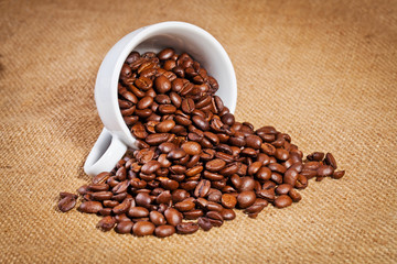 coffee cup and arabica beans on cloth sack