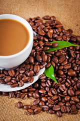 Fototapeta premium coffee cup and arabica beans on cloth sack