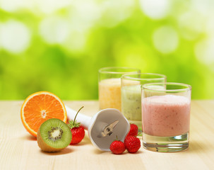Fruit smoothie on wooden table on narural background
