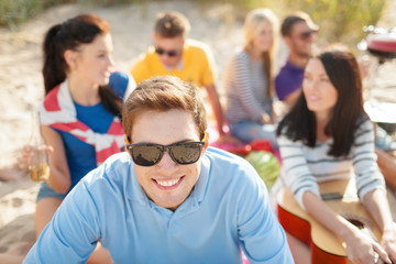 smiling man in sunglasses on the beach