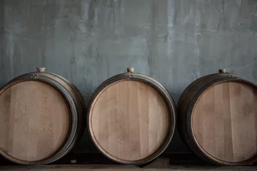 Gardinen Wine barrels stacked in the cellar of the winery © arthurhidden