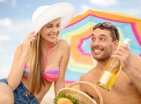 Smiling Couple Having Picnic On The Beach