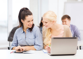 students with laptop, tablet pc and notebooks