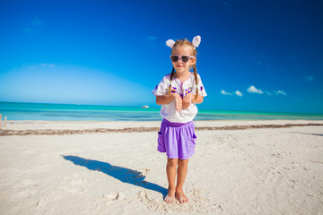 Adorable little girl in easter costume on the exotic beach