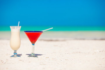 Two cocktails: pina colada and strawberry margarita on white