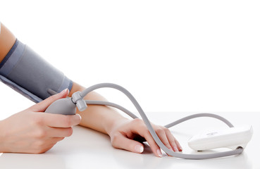 Female measures her blood pressure