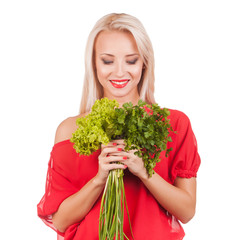 Young beautiful girl holding two bunches of parsley