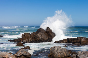 Waves crashing against boulders