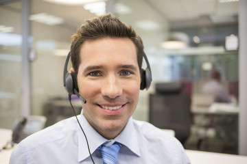 Businessman in the office on the phone with headset - obrazy, fototapety, plakaty