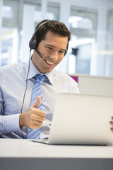 Businessman in the office on the phone with headset, Skype