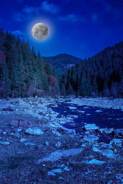 river  rocky shore near the mountain in moonlight