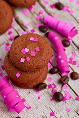 Fototapeta na wymiar fresh chocolate cookies, coffee beans, pink ribbons and confetti