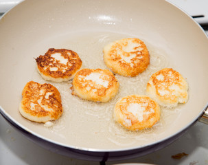 pancakes are fried in a pan