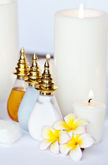 Three Plumeria flower with massage oil and balsam in bowl 
