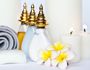 Three Plumeria flower with massage oil and balsam in bowl 
