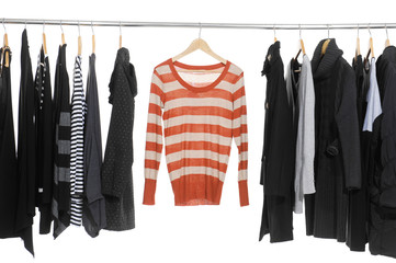 Variety of casual fashion clothing hanging on hangers