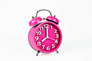 Retro pink alarm clock isolated on white