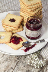 Homemade sugar cookies with jam decorated with flowers.