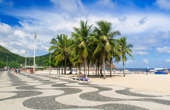 Copacabana with palms and mosaic of sidewalk in Rio de Janeiro