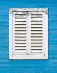 Old white window with wooden shutters.