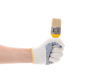 Hand in gloves holds brush.