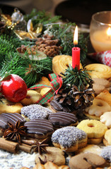 Fototapeta na wymiar Mix of Christmas cookies with cinnamon and candle