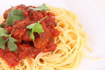 Pasta with meatballs decorated with coriander