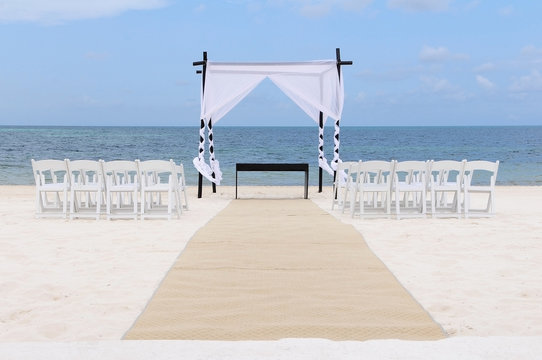 Wedding set up on the beach. Canopy, chairs and carpet