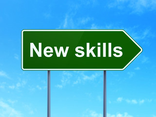 Education concept: New Skills on road sign background