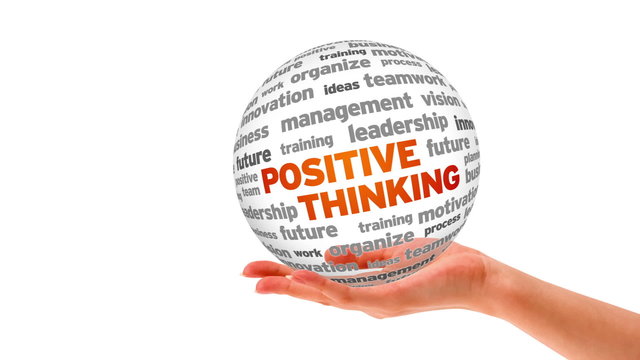 A person holding a 3d Positive thinking word sphere