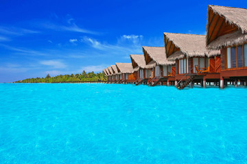 Blue tropical lagoon with water willas on Maldives