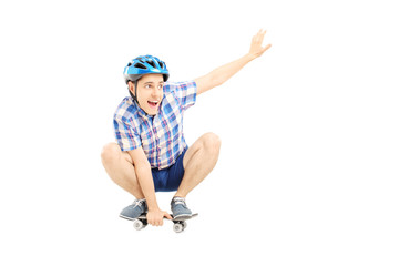 Happy guy with helmet skating on a skate board