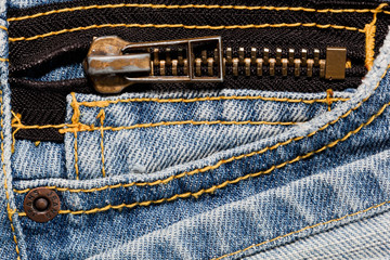 Blue jeans close up on a pocket and a zipper.