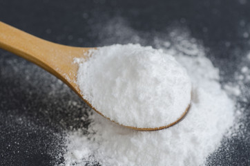 Sodium bicarbonate in a wooden spoon - obrazy, fototapety, plakaty