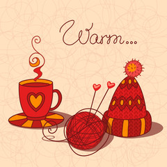 A cup of warm tea, wool and knitted cap