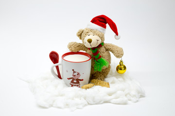 Christmas teddy bear with a cup of milk