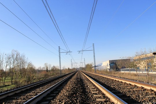 Two sets of railroad tracks run straight and parallel
