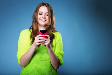 Happy girl with mobile phone reads message