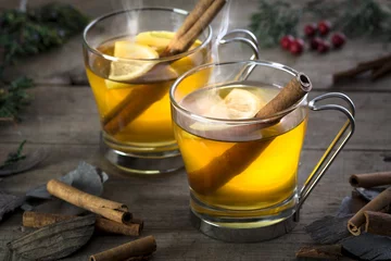 Tuinposter Two Hot Toddy Cocktail Drinks with Cinnamon and Lemon © jefftakespics2