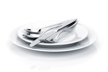 Silverware or flatware set of fork, spoons and knife on plates