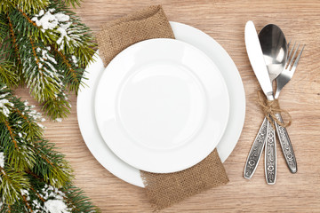 Fototapeta na wymiar Empty plate and silverware set with christmas tree